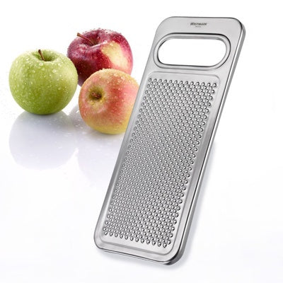 Westmark Appel- en Aardappelrasp, zilver, rasp naast drie verse appels