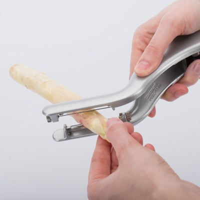 Westmark Peel-Star Alu Dubbele Aspergeschiller, zilver, in gebruik bij het schillen van een witte asperge