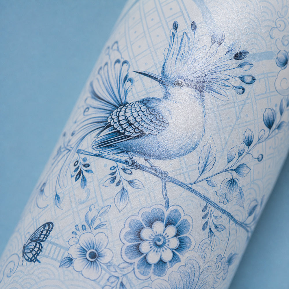 Close-up van de witte vogel met blauw bloemenmotief op de IZY Thermosfles Soft Azure