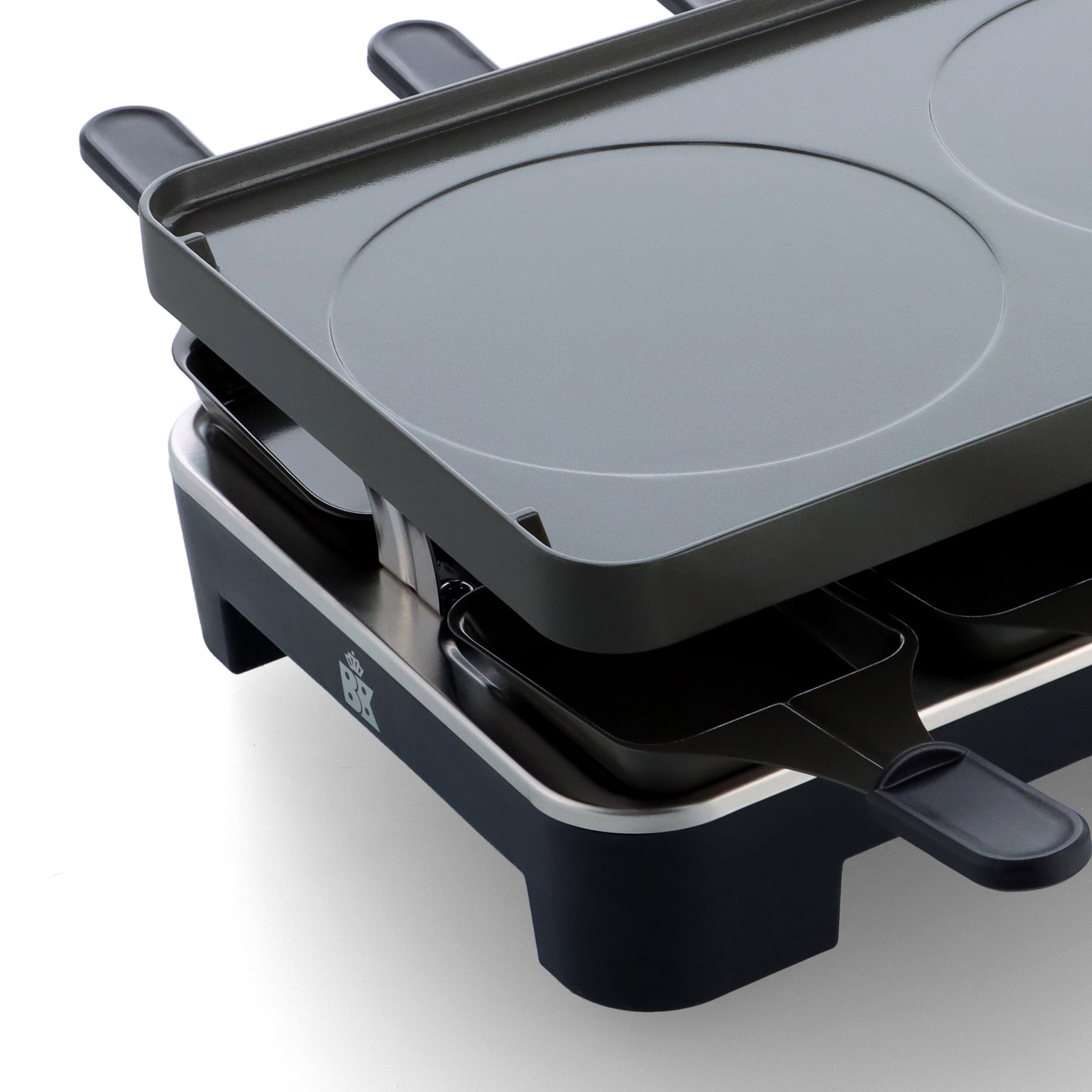 Detail van de zwarte BK Connect raclette met bakplaat en pannetjes eronder.
