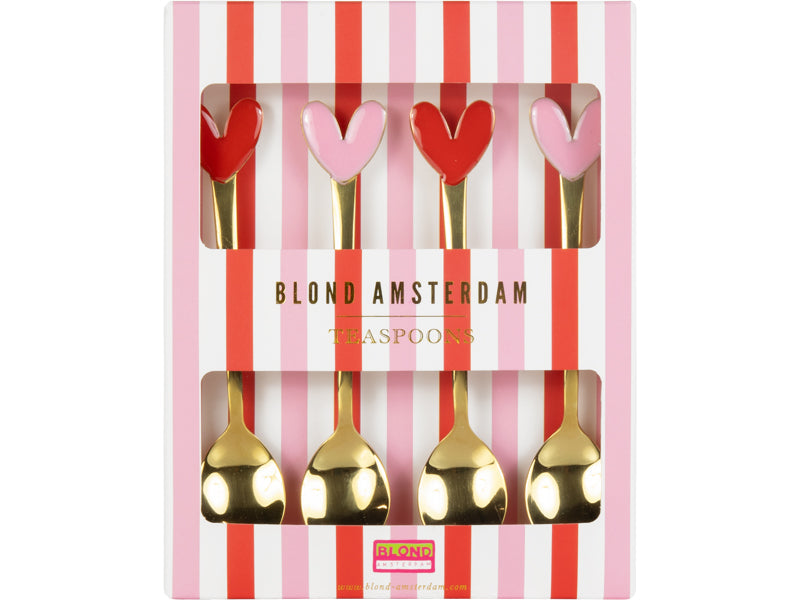 De set van vier theelepels in de roze en rood gestreepte verpakking