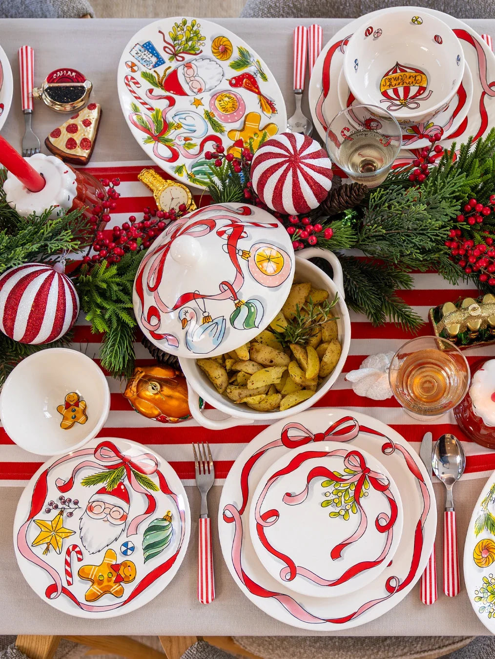 Het ovale bord op de kersttafel naast de soepterrine en andere borden met lint